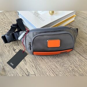 TUMI NYLON WAIST PACK. COLOR - GREY & ORANGE. NWT